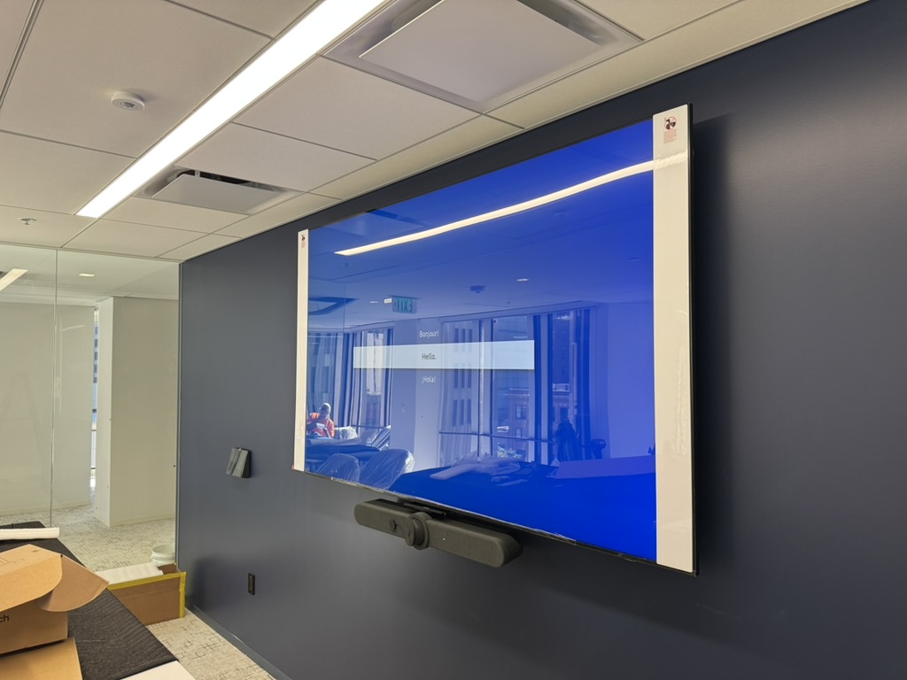 Large wall-mounted display and soundbar during testing at Boston Properties