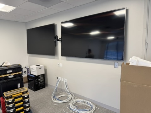 Dual-display room with centered PTZ camera at the GGRC Marin office