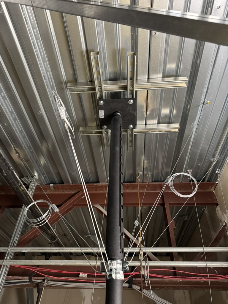 Projector support structure with unit strut and aircraft cable at KLA-AHA