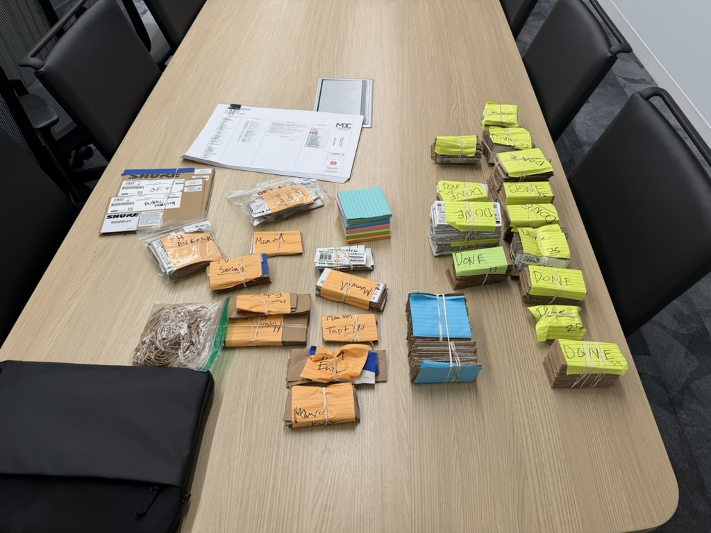 Organized SamTrans device-ingestion batches on a conference table